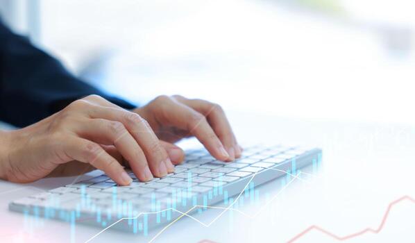 Close-up of hands typing on keyboard with financial stock chart overlay. Business data analysis, fintech, online trading, and digital technology concept in modern workspace. photo
