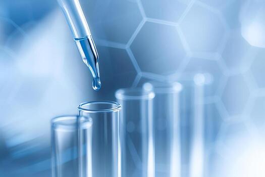 close up of blue liquid droplet from pipette falling into clear test tubes with hexagonal abstract background symbolizing precision technology and scientific innovation photo