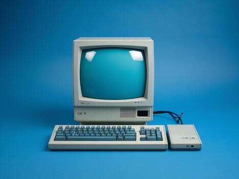 Retro computer setup featuring a CRT monitor and keyboard on a blue background. photo