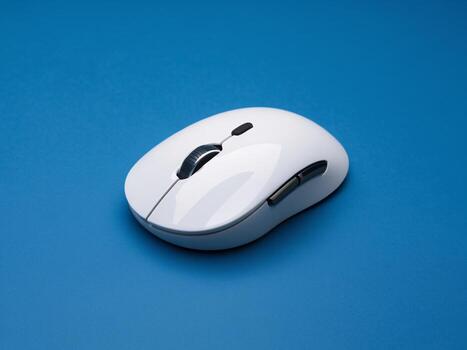 Sleek white computer mouse on a vibrant blue background, showcasing modern design and functionality. photo