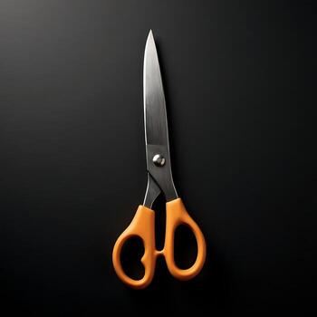 Scissors with Orange Handle on Black Background Minimalist Still Life photo