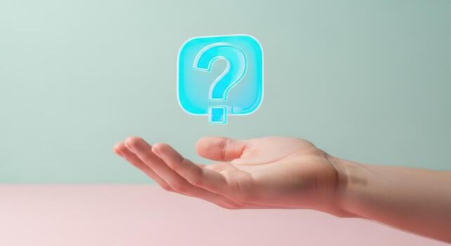 Hand holding a question mark on a pink background photo
