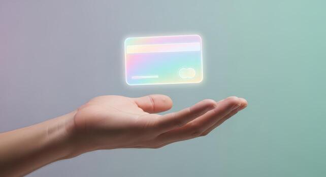 A hand holding a credit card with a rainbow colored background photo