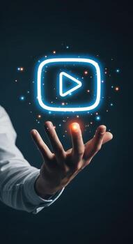 A man holding up a glowing play button photo