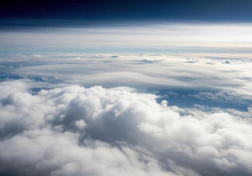 Aerial view of fluffy white clouds and blue sky from airplane photo