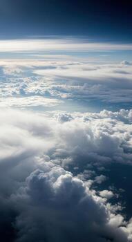 Aerial view of clouds from airplane window during daytime flight photo