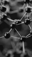 Abstract 3D render of glossy black molecular structure on dark background. Futuristic, scientific, and high-tech concept for innovation, chemistry, or nanotechnology themes. video