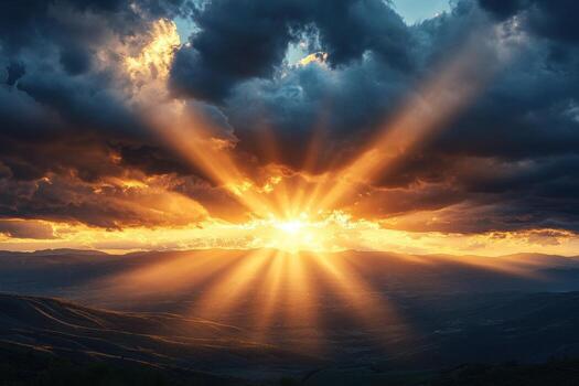 The sun shines through the clouds over a mountain range photo