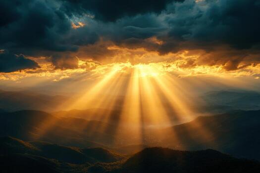 Sunbeams shining through clouds over mountains photo