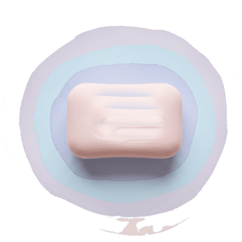 Aerial view of a bar of soap on a light blue surface with a circular gradient design around it on transparent background png