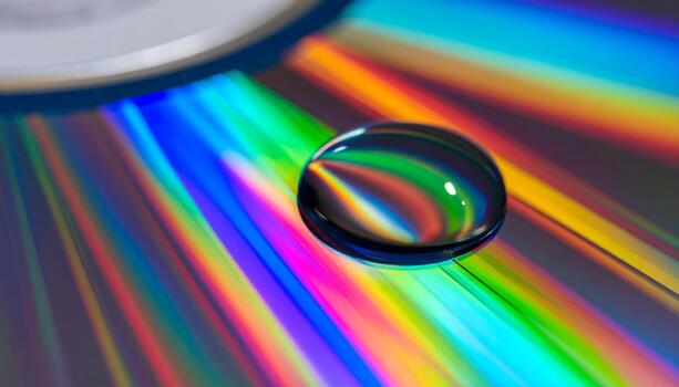 Water Drop on Rainbow CD Surface, Macro Abstract. photo