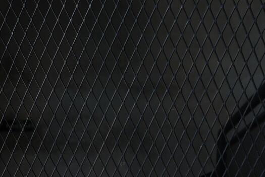 Full frame shot of black chainlink fence. wire for the background. photo