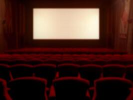 borroso imagen de un clásico película teatro con rojo terciopelo asientos y un pantalla ancha monitor. foto