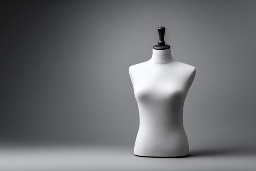 Dressmaker's dummy torso isolated on a grey background photo