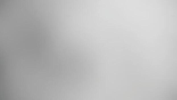 A soft, blurred image featuring shades of gray, creating a minimalist and abstract atmosphere.dark gray background vector