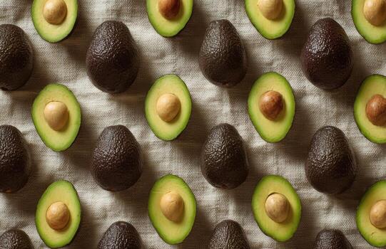 Fresh avocados forming a pattern on linen cloth photo