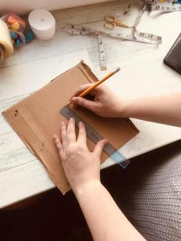 Creating a craft project with ruler and pencil in home workspace photo