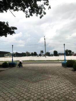 Cloudy sky over empty park with stroller on pathway photo