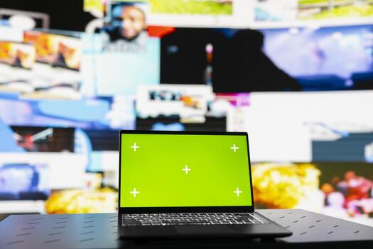 Laptop showcasing display with green screen mockup next to modern web design social network platforms, visual representation of trends and mobile interaction. Empty space for user experience. photo