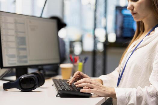 Close up of programmer designing and developing software applications, optimizing code for performance and scalability. IT expert in office using PC to resolving bottlenecks photo