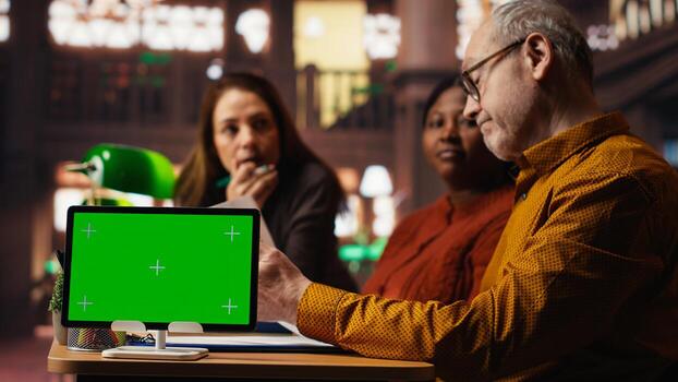 Actors team rehearsing together in a library next to isolated copy space, practicing lines and doing role preparation with focus and dedication. Commitment to classic drama performance. photo