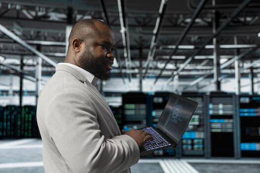 Engineer working in data center providing computing resources and storage to enable AI training and inference. IT expert using machine learning tech to optimize operations and efficiency photo