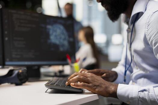 Close up of engineer typing on PC keyboard, coding with AI language model assistance. IT expert writing code, doing software development using artificial intelligence LLM assistant suggestions photo