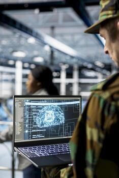 Close up of army tech expert in data center tracking threats using AI machine learning models. Server farm worker supporting autonomous systems with artificial intelligence technology photo