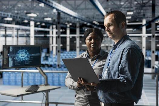 Teamworking data center technicians analyzing equipment performance, resolving technical issues. Server farm coworkers doing job tasks, overseeing operations, implementing efficiency optimizations photo
