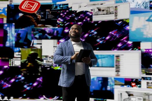 Black young social network user checks dashboards with dynamic screens showcasing social media and networking, highlighting the importance of online engagement and global connection. photo