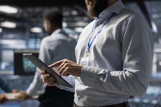 Close up of data center technician does AI deep learning automatization for infrastructure, working on elevated industrial platform. Engineer maintaining server rigs using artificial intelligence. photo