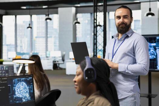 Portrait of team leader supervising programmers at work training deep learning models for anomaly detection. Supervisor overseeing IT workers using artificial intelligence in office to do tasks photo