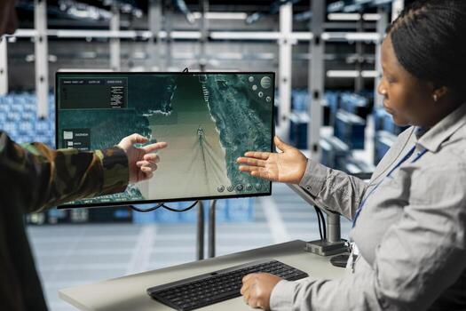 Team of military engineers in data center tracking satellite coordinates using monitor interface. Teamworking server room coworkers analyzing reconnaissance data through satellite imaging systems photo