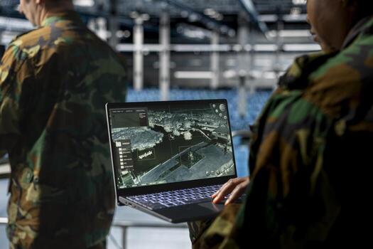 Close up of military technician in data center tracking satellite coordinates using laptop interface. IT specialist in server room analyzing reconnaissance data through satellite imaging systems photo