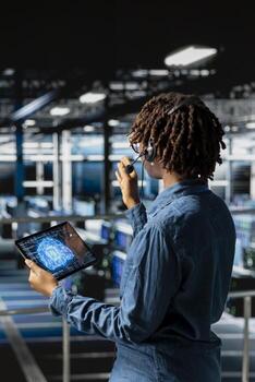 Server hub IT specialist monitoring systems and doing tech support, guiding users through troubleshooting steps. African american expert providing remote diagnostics using headset mic. photo