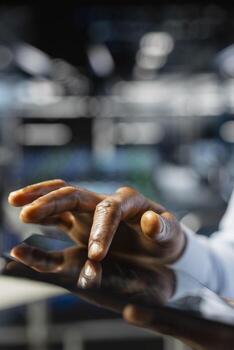 Close up of data center software developer doing maintenance tasks on tablet, ensuring optimal performance. Male worker reviewing diagnostics and debugging server hub high tech equipment. photo