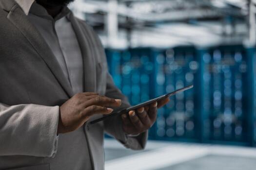 Close up of data center admin using tablet to protect servers from exploitable software vulnerabilities, auditing systems. Cybersecurity specialist using notebook looking for bugs slowing down servers photo