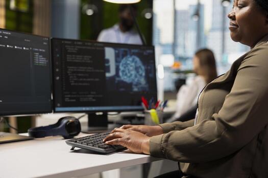 Close up of programmer writing code, developing deep learning APIs. Tech startup office employee troubleshooting application errors using artificial intelligence on computer photo