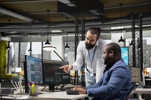 Administrator and assistant gather data from monthly reports, reviewing performance metrics and creating graphs that align with project goals. Teamwork for innovation and achievement. photo