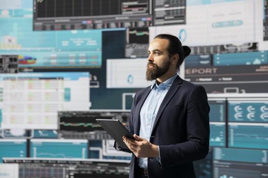 Surrounded by fintech data and forecasting models, entrepreneur analyzes data and insight to drive business growth. Company performance and smart decision making through innovation. photo