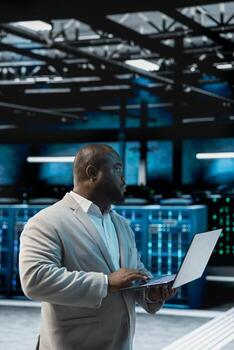 Data center admin running system diagnostic tests and error checking utilities, automating anomaly detection. IT expert monitoring server performance, looking for network issues affecting rigs photo