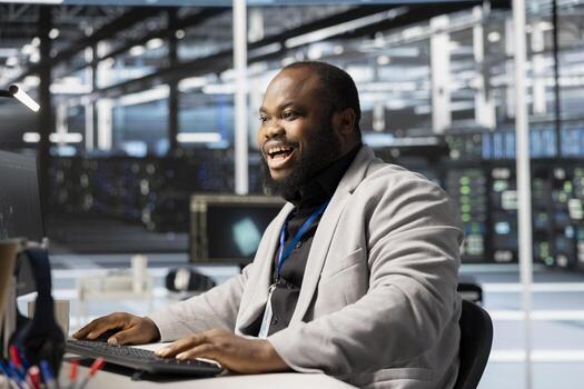 Cheerful software developer in data center checking infrastructure health report showing stable performance indicators. Upbeat server room employee delighted after successfully completing operations photo