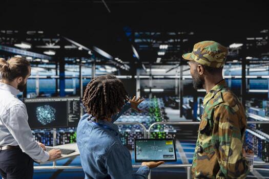 Army operators in server hub using device to run drone control software, looking at mission map overlay via satellite imagery. Diverse military experts develop national defense strategy. photo