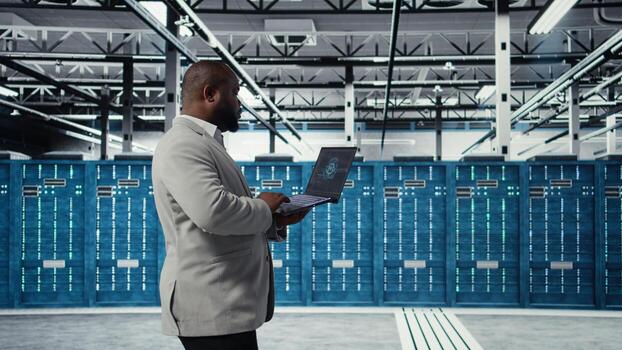 Data center admin doing IT maintenance tasks using AI technology. Server hub engineer providing tech support after identifying hardware issues using predictive artificial intelligence alerts, camera A photo