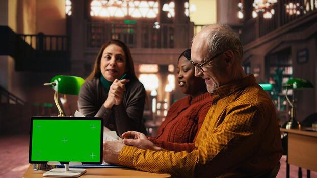 Diverse performers team preparing for theatre play with green screen, practicing script and dialogue lines with discipline and passion. Developing their characters with love for acting. photo