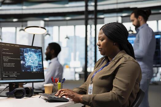 Software engineer using AI automation in tech workspace, building digital solutions. African american IT specialist working on PC to identify and fix bugs using artificial intelligence tools photo
