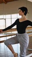 Ballet dancer practices at the studio during a sunny afternoon in a spacious mirror-lit space video