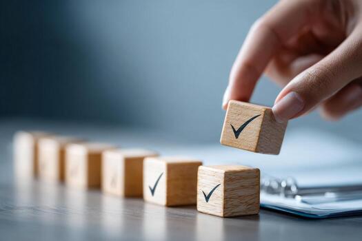 Checklist and task progress tracking concept. A hand placing the final checkmark on wooden blocks in progress bar photo