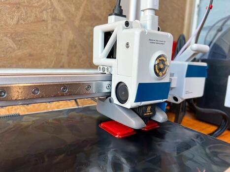 3d printer extruder creating an object layer by layer photo