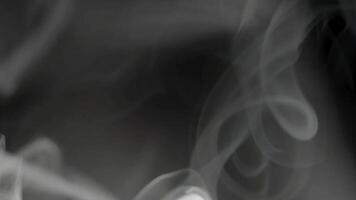 White smoke swirling in slow motion on dark background video